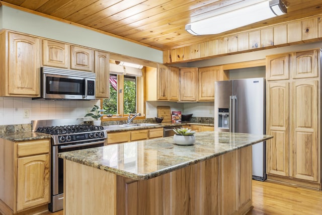 26517 Farm Rd Unit 1212, Eagle Rock, MO 65641 - kitchen featuring stainless steel appliances, dark stone counters, ornamental molding, a kitchen island, and a sink