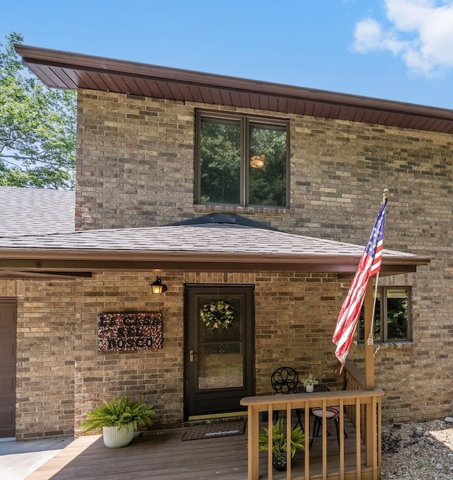 26517 Farm Rd Unit 1212, Eagle Rock, MO 65641 - view of exterior entry with brick siding, a wooden deck, and roof with shingles