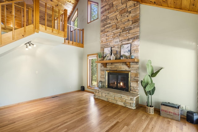 26517 Farm Rd Unit 1212, Eagle Rock, MO 65641 - unfurnished living room with wood ceiling, high vaulted ceiling, wood finished floors, a fireplace, and baseboards