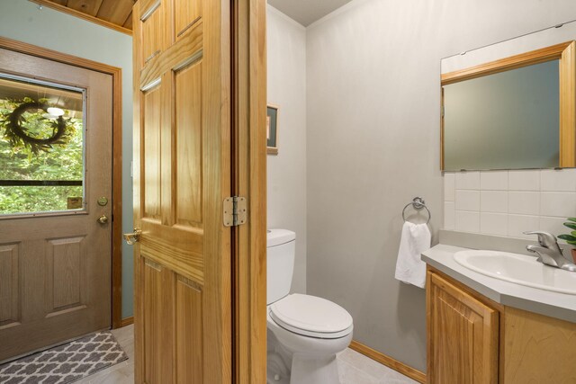 26517 Farm Rd Unit 1212, Eagle Rock, MO 65641 - half bath with vanity, decorative backsplash, toilet, tile patterned flooring, and baseboards