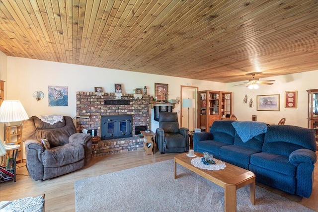 1900 State Highway 76, Anderson, MO 64831 - living room featuring ceiling fan, light wood-style floors, wooden ceiling, and a brick fireplace