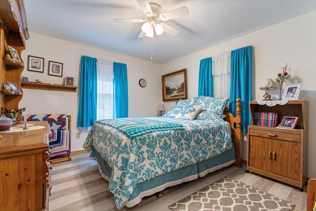 1900 State Highway 76, Anderson, MO 64831 - bedroom featuring light wood-style flooring, ceiling fan, and a textured ceiling
