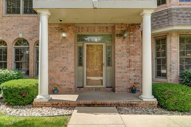 2411 W Dearborn St, Springfield, MO 65807 - view of exterior entry with brick siding, covered porch, and a security system