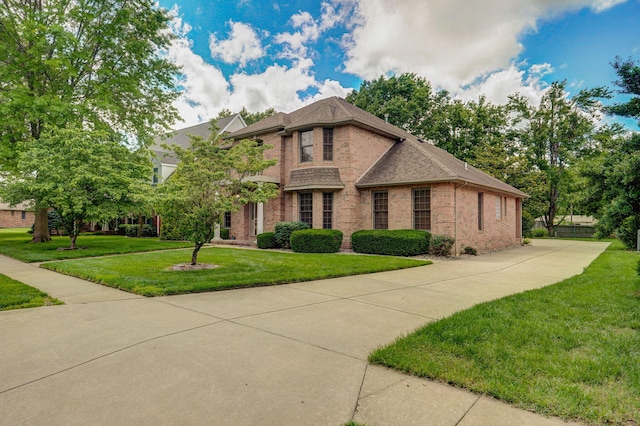 2411 W Dearborn St, Springfield, MO 65807 - traditional-style home with brick siding, a front lawn, and a shingled roof