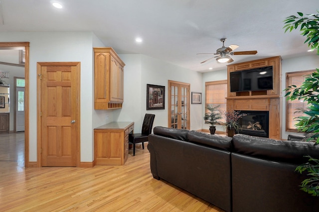 2411 W Dearborn St, Springfield, MO 65807 - living area with light wood finished floors, a ceiling fan, a fireplace, recessed lighting, and french doors