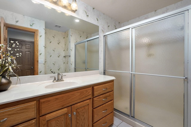 2411 W Dearborn St, Springfield, MO 65807 - bathroom featuring wallpapered walls, vanity, a shower stall, and tile patterned floors
