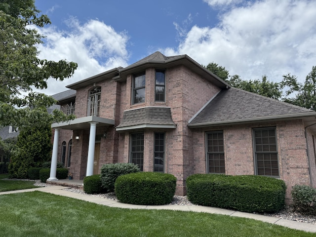 2411 W Dearborn St, Springfield, MO 65807 - view of front of home with brick siding, a balcony, a shingled roof, and a front yard