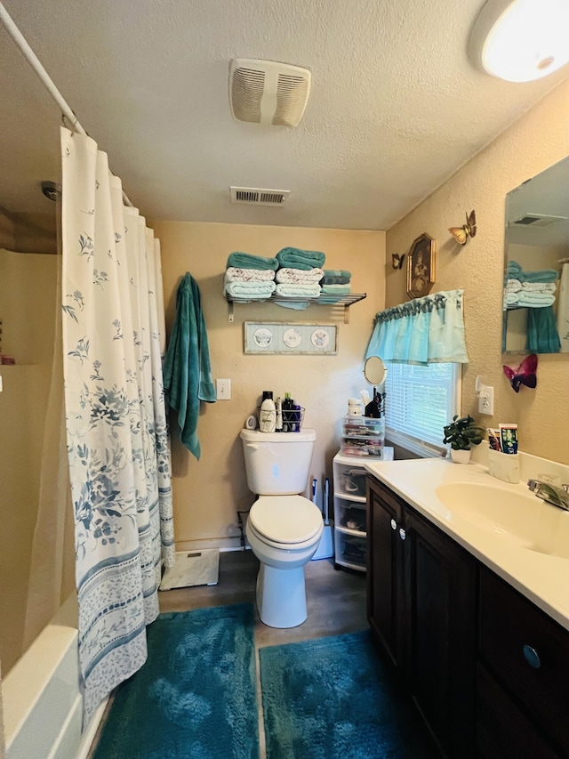 720 Highland St, Cabool, MO 65689 - bathroom featuring vanity, toilet, a textured ceiling, and shower / bath combo