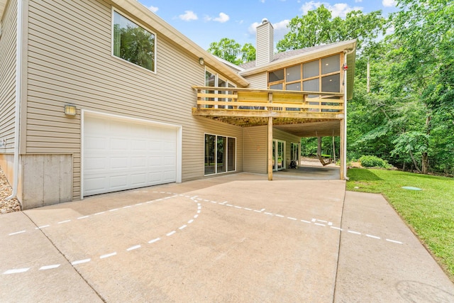 159 Oak Tree Point Ln, Shell Knob, MO 65747 - rear view of house featuring a garage, concrete driveway, a deck, a chimney, and a lawn