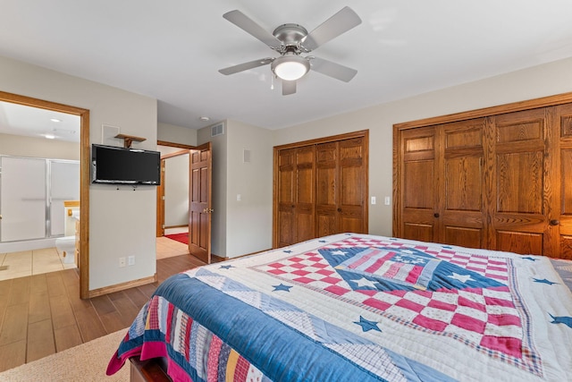 159 Oak Tree Point Ln, Shell Knob, MO 65747 - bedroom featuring multiple closets, wood finished floors, a ceiling fan, and ensuite bathroom