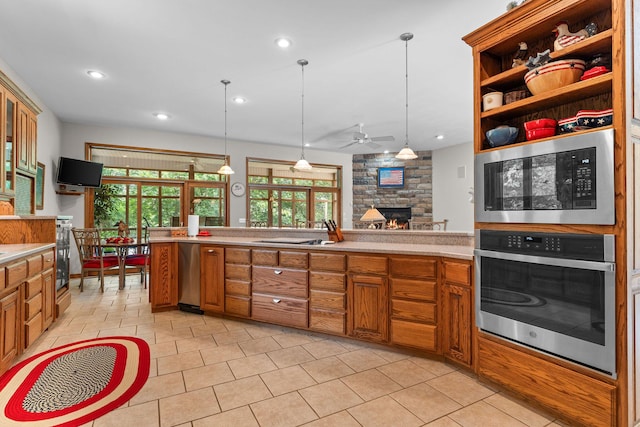 159 Oak Tree Point Ln, Shell Knob, MO 65747 - kitchen with appliances with stainless steel finishes, a stone fireplace, brown cabinets, light countertops, and recessed lighting