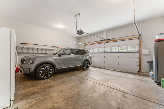 159 Oak Tree Point Ln, Shell Knob, MO 65747 - garage with freestanding refrigerator and a garage door opener