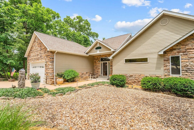 159 Oak Tree Point Ln, Shell Knob, MO 65747 - view of front of house with stone siding, a garage, and roof with shingles