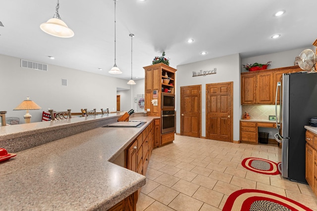 159 Oak Tree Point Ln, Shell Knob, MO 65747 - kitchen featuring stainless steel appliances, recessed lighting, brown cabinetry, pendant lighting, and backsplash