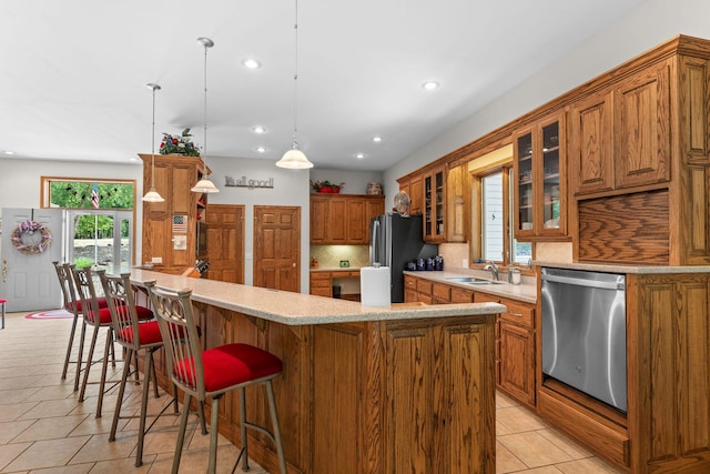 159 Oak Tree Point Ln, Shell Knob, MO 65747 - kitchen with appliances with stainless steel finishes, brown cabinetry, light tile patterned floors, a sink, and recessed lighting