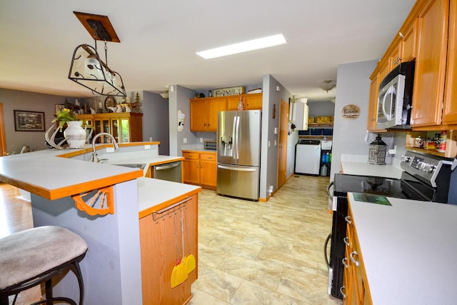 22920 Feaster Branch Rd, Warsaw, MO 65355 - kitchen with stainless steel appliances, a sink, washer / dryer, and light countertops