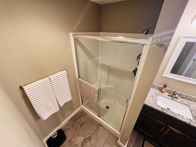 607 E Selby Dr, Nixa, MO 65714 - bathroom featuring a stall shower, marble finish flooring, and vanity
