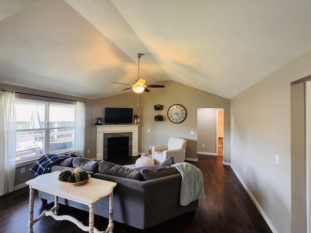 607 E Selby Dr, Nixa, MO 65714 - living area with lofted ceiling, a ceiling fan, a tile fireplace, and dark wood finished floors
