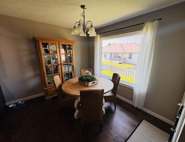 607 E Selby Dr, Nixa, MO 65714 - dining area featuring a chandelier, dark wood-style floors, and a textured ceiling