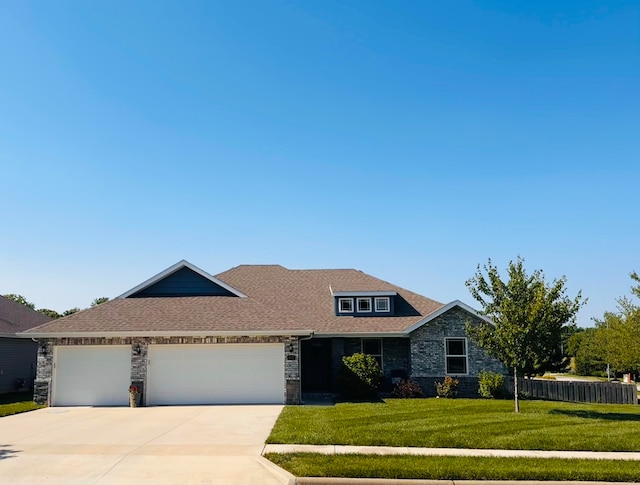 607 E Selby Dr, Nixa, MO 65714 - view of front of home with an attached garage, driveway, and stone siding