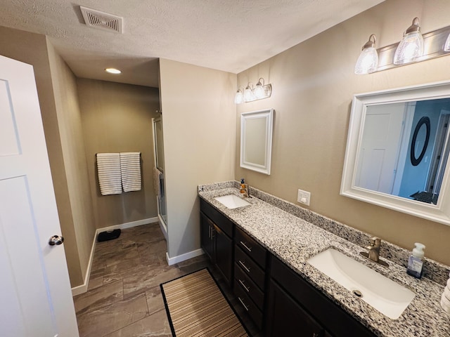 607 E Selby Dr, Nixa, MO 65714 - full bathroom with a shower stall, double vanity, and a textured ceiling