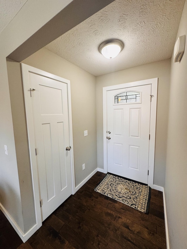607 E Selby Dr, Nixa, MO 65714 - entryway featuring dark wood-style flooring and a textured ceiling
