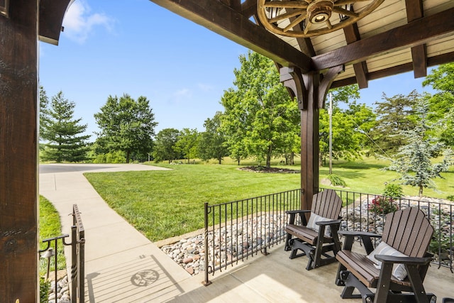 1029 Riverview Rd, Clever, MO 65631 - covered porch with a lawn, ceiling fan, and view of scattered trees