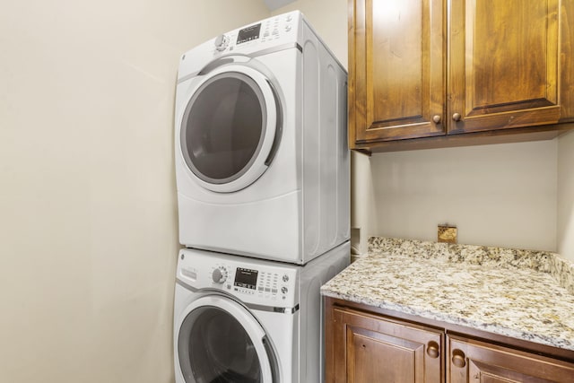 1029 Riverview Rd, Clever, MO 65631 - laundry room featuring cabinet space and estacked washer and dryer