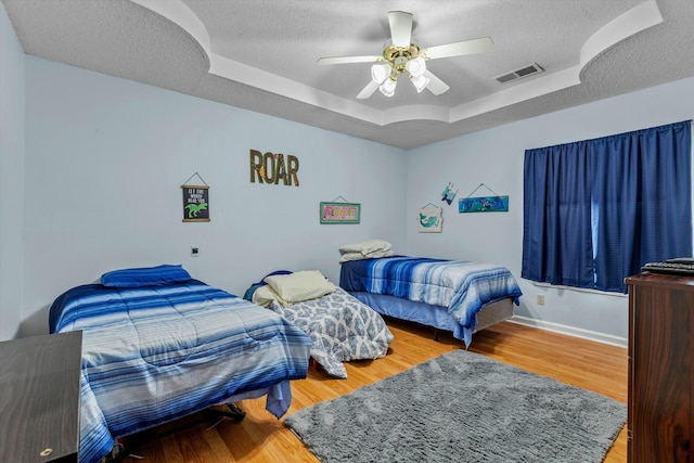 310 Woodland Dr Unit Lb, Branson, MO 65616 - bedroom with a raised ceiling, a textured ceiling, wood finished floors, and ceiling fan
