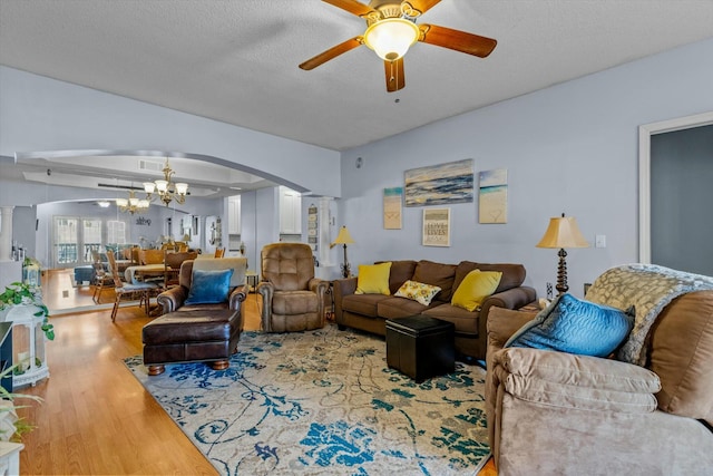 310 Woodland Dr Unit Lb, Branson, MO 65616 - living room with arched walkways, ceiling fan, a chandelier, wood finished floors, and decorative columns