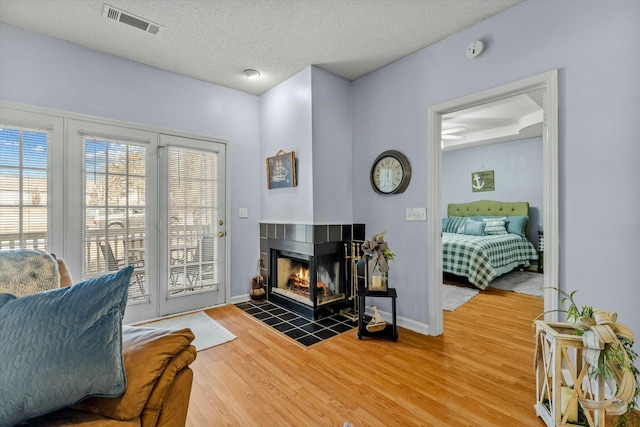 310 Woodland Dr Unit Lb, Branson, MO 65616 - living room with wood finished floors, a textured ceiling, and a tiled fireplace