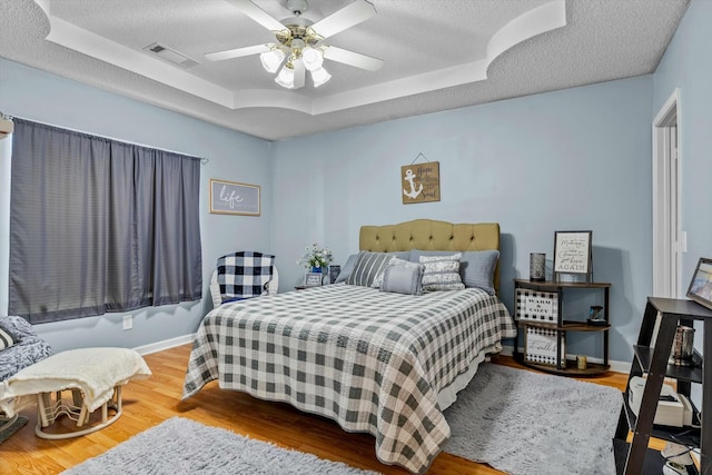310 Woodland Dr Unit Lb, Branson, MO 65616 - bedroom with a tray ceiling, a textured ceiling, wood finished floors, and ceiling fan
