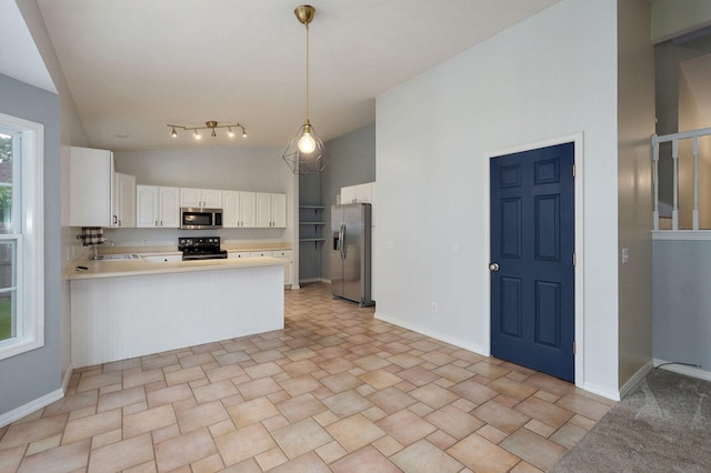 713 River Rock Ct, Nixa, MO 65714 - kitchen featuring appliances with stainless steel finishes, vaulted ceiling, a peninsula, white cabinetry, and light countertops