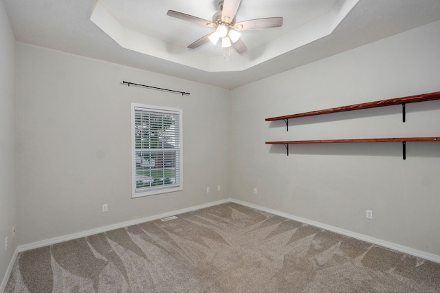 713 River Rock Ct, Nixa, MO 65714 - carpeted spare room featuring a tray ceiling and a ceiling fan
