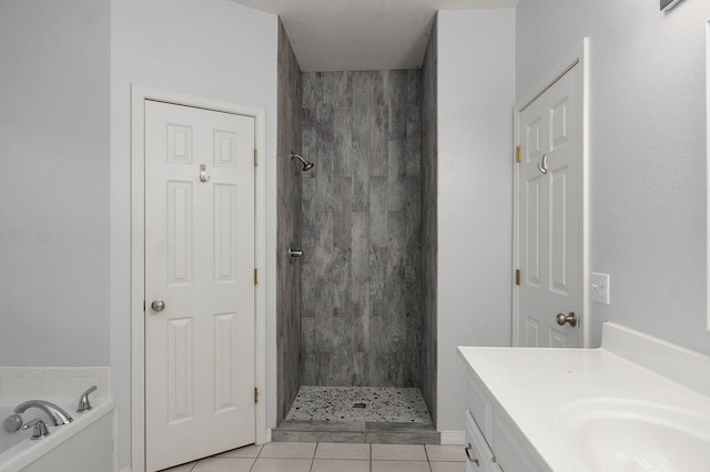 713 River Rock Ct, Nixa, MO 65714 - full bathroom featuring a stall shower, a garden tub, tile patterned flooring, and vanity