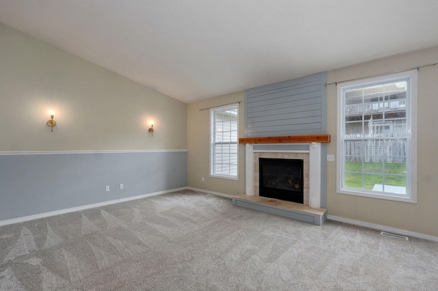 713 River Rock Ct, Nixa, MO 65714 - unfurnished living room with carpet floors, plenty of natural light, a tiled fireplace, and vaulted ceiling