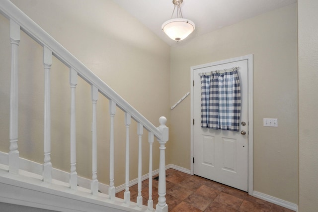 713 River Rock Ct, Nixa, MO 65714 - entrance foyer featuring stairway and dark stone finish floors
