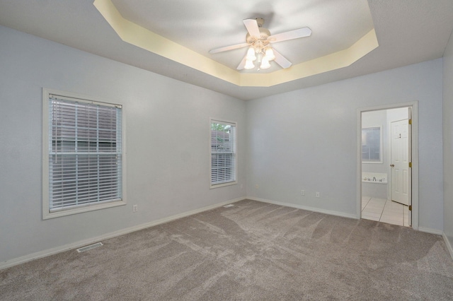 713 River Rock Ct, Nixa, MO 65714 - unfurnished room with carpet, a raised ceiling, and ceiling fan