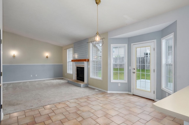 713 River Rock Ct, Nixa, MO 65714 - unfurnished living room with plenty of natural light, a fireplace with raised hearth, and carpet flooring