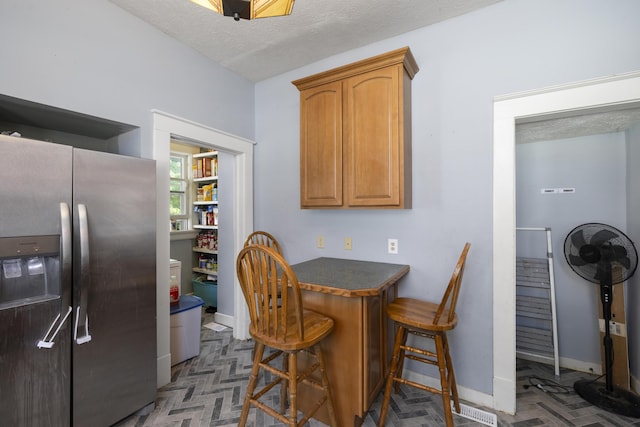817 W Walnut St, Springfield, MO 65806 - dining area featuring a dry bar and a textured ceiling