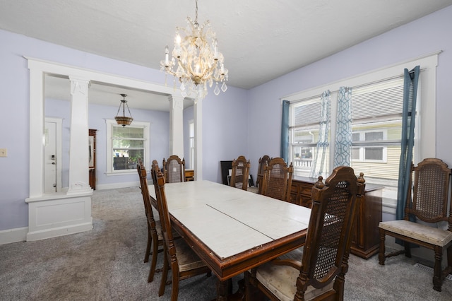 817 W Walnut St, Springfield, MO 65806 - carpeted dining space featuring a chandelier and ornate columns