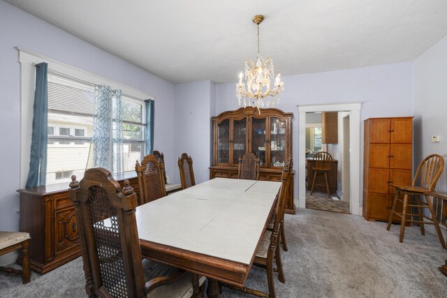 817 W Walnut St, Springfield, MO 65806 - dining space featuring a chandelier and light carpet