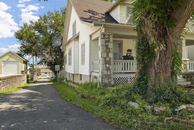 817 W Walnut St, Springfield, MO 65806 - view of home's exterior featuring a shingled roof, driveway, and covered porch