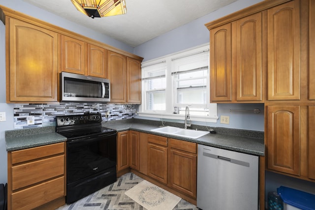 817 W Walnut St, Springfield, MO 65806 - kitchen featuring stainless steel appliances, dark countertops, tasteful backsplash, and brown cabinetry
