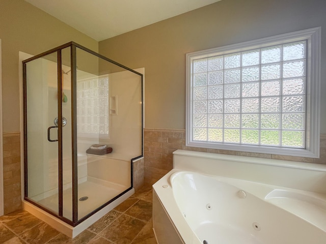 4910 S Stanton Ave, Springfield, MO 65810 - bathroom with tile walls, a shower stall, a jetted tub, and wainscoting
