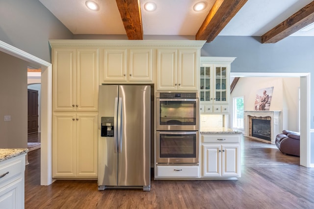 4910 S Stanton Ave, Springfield, MO 65810 - kitchen featuring stainless steel appliances, beam ceiling, dark wood-type flooring, light stone counters, and recessed lighting