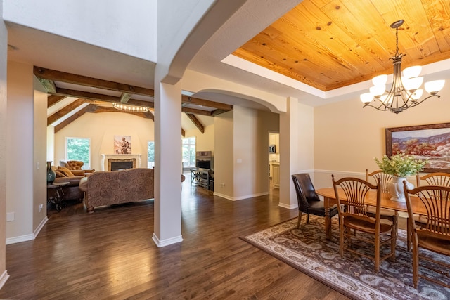4910 S Stanton Ave, Springfield, MO 65810 - dining space featuring wooden ceiling, arched walkways, a chandelier, dark wood finished floors, and a fireplace