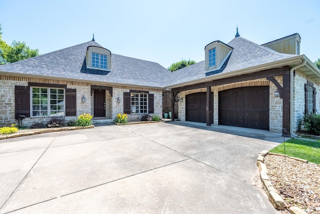 4910 S Stanton Ave, Springfield, MO 65810 - french country inspired facade featuring a garage, roof with shingles, concrete driveway, and stone siding