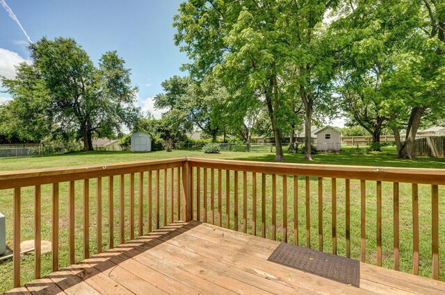1651 S Mahn Ct, Springfield, MO 65802 - wooden deck with a storage unit and a fenced backyard