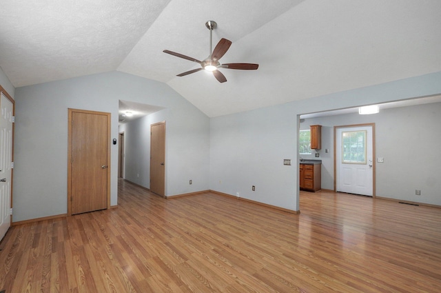 1651 S Mahn Ct, Springfield, MO 65802 - unfurnished living room featuring ceiling fan, light wood finished floors, and vaulted ceiling